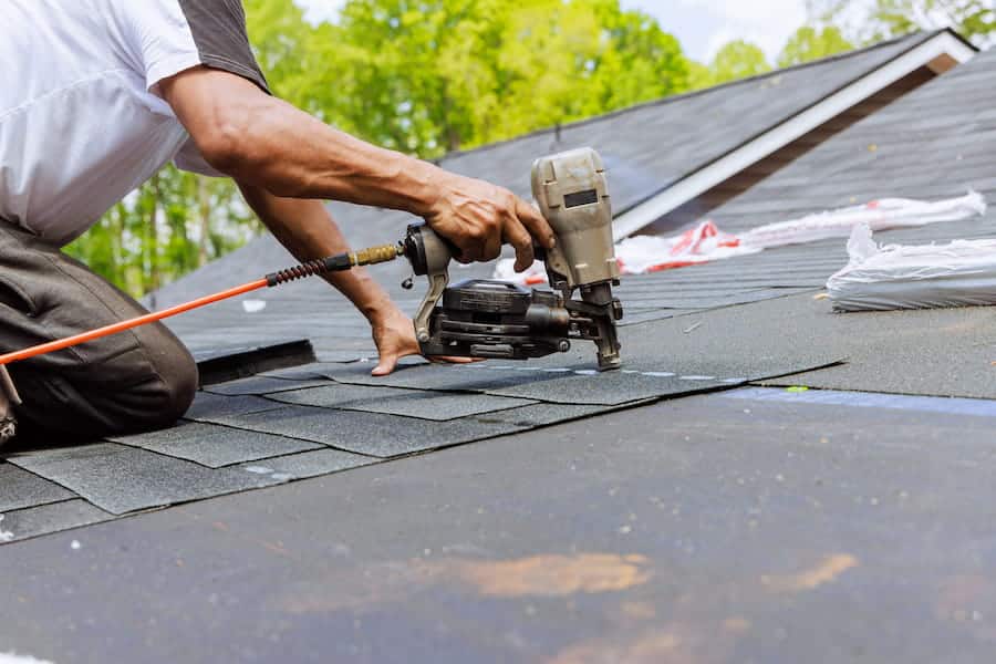 Roofer Replacing Shingles on a Residential Home
