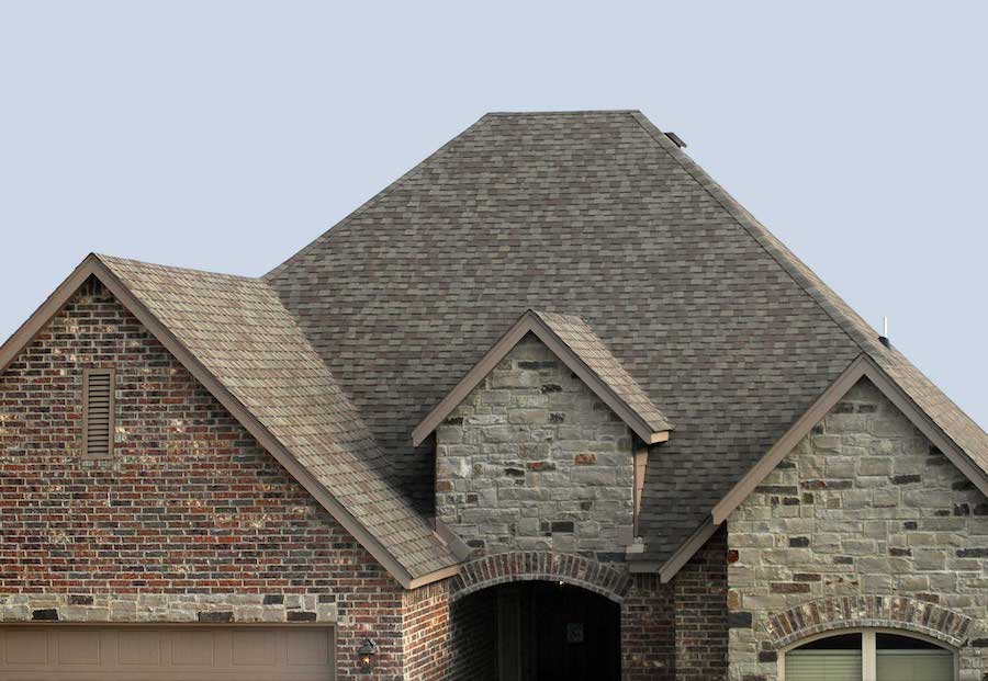 Residential roof with manufacturer-backed asphalt shingles