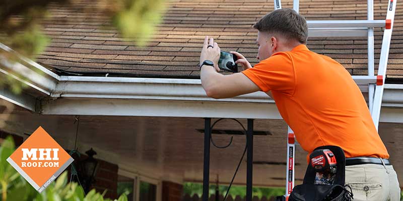 Roof inspection identifying damaged shingles before replacement