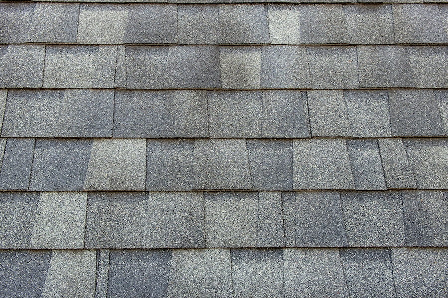 Close-up view of asphalt shingles showing protective mineral granules
